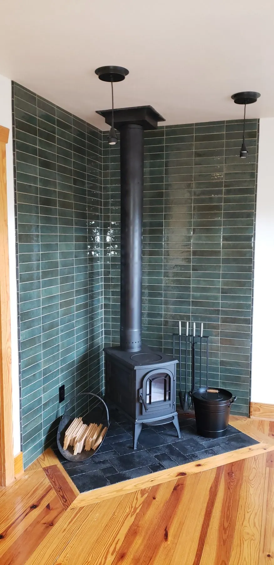 Finished hearth tile installation with wood-burning stove