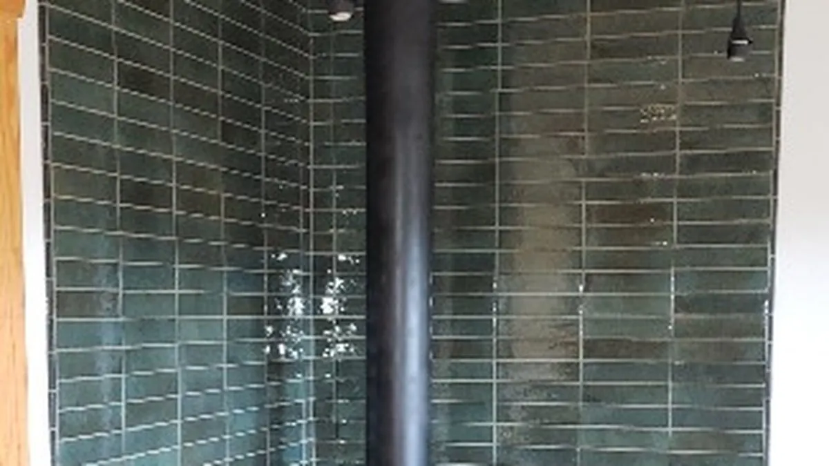 Green tile hearth installation around a wood stove