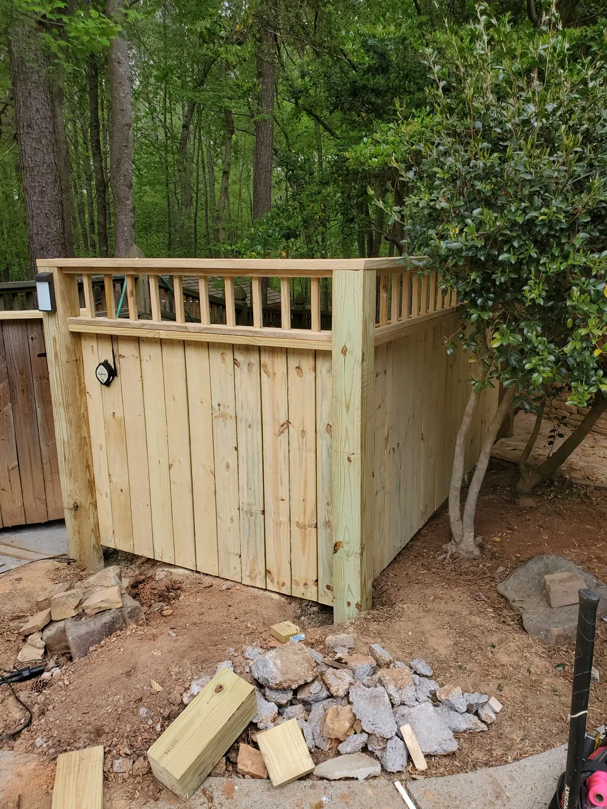 Custom pressure-treated wood trash enclosure with lighting